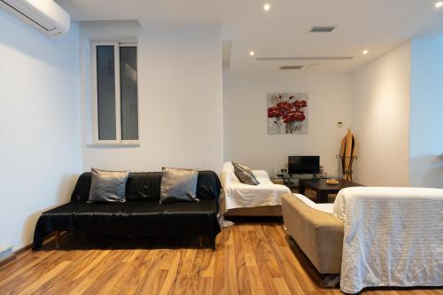 a living room with a couch and a table at Blue Line Sliema in San Pawl il Bahar