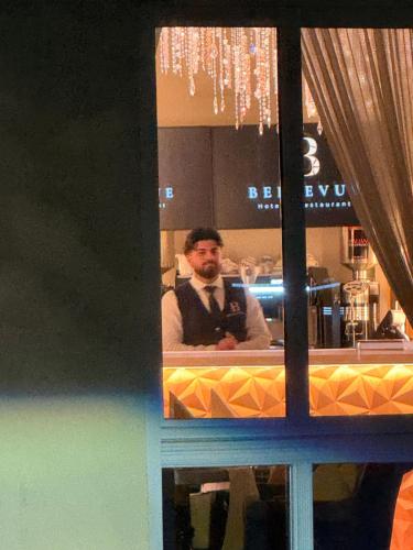 a man reflection in a mirror in a kitchen at Hotel & Restaurant Bellevue Schmölln in Schmölln