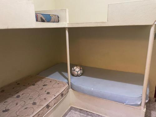 a small bed in a bunk room at Apartamentos Dona Marlene in São Francisco de Itabapoana