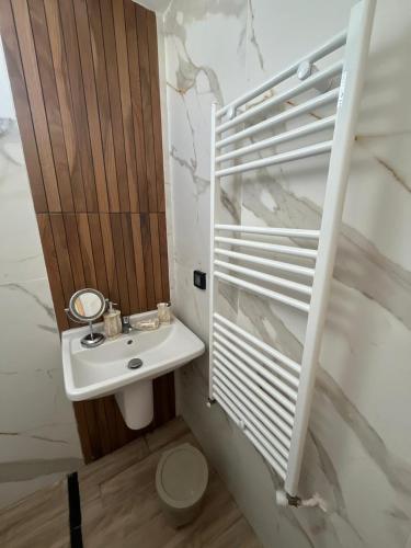 a white bathroom with a sink and a toilet at issac in Monastir