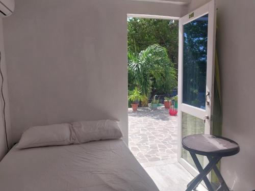 a bedroom with a bed and an open door at Posada for Living in San Andrés