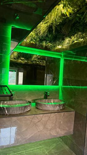two green lights on the wall of a building at Nuit D Or LoveRoom in Bellegarde-sur-Valserine
