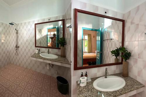 a bathroom with two sinks and a mirror at Filladhoo inn in Filadu
