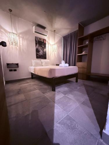 a bedroom with a large bed in a room at condo pacha tulum in Tulum