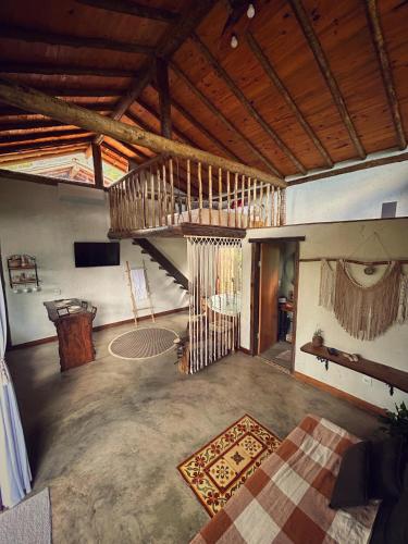 a large living room with a staircase in a house at loft Ágata in Brumadinho