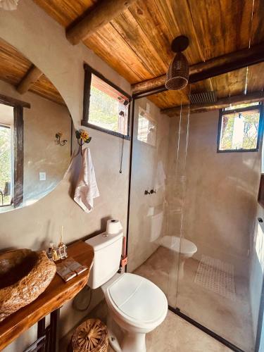 a bathroom with a shower and a toilet and a sink at loft Ágata in Brumadinho