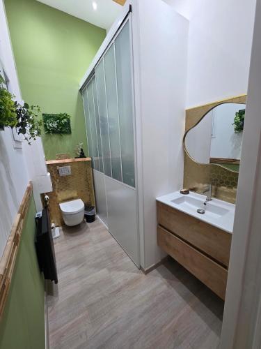 a bathroom with a shower and a sink and a toilet at Le Baiser Doré in Sainte-Marie-aux-Chênes