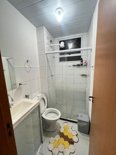 a small bathroom with a toilet and a sink at Ap Hostel For You in Serra
