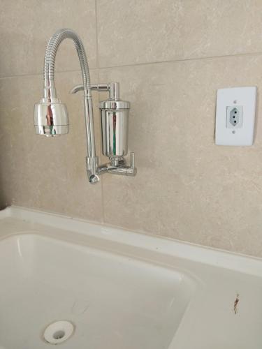 a bathroom with a bath tub and a sink at Microcasa loft in São Pedro da Aldeia