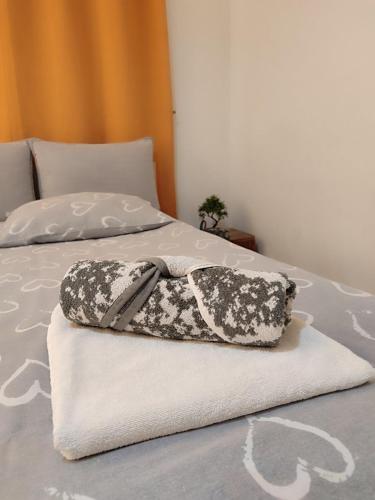 a black and white pillow sitting on a bed at Sarajevo Main Street Residence in Sarajevo