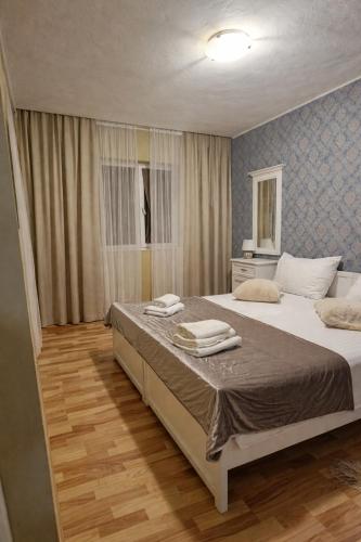 a bedroom with a large bed with towels on it at Zadar Kali Booking Franov Residence on island Ugljan with the pool, BBQ and beautiful sea-view! in Kali