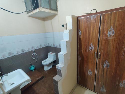 a bathroom with a toilet and a sink at Al Hidayah Hotel Multan in Multan