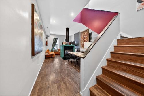 a hallway with stairs and a living room at Stylish STL Gem ABODEbucks in Saint Louis