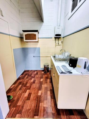 a kitchen with a counter and a wooden floor at Her Home in Purranque