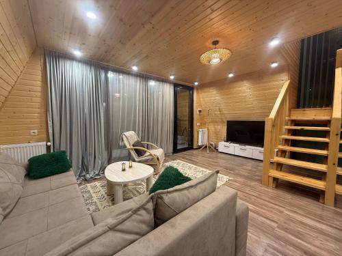 a living room with a couch and a table at WoodCottage in Borjomi