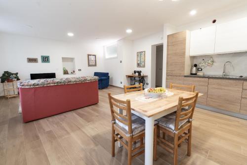 a kitchen and dining room with a table and chairs at La bottega del sarto in Grumes