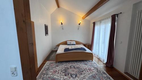 a bedroom with a bed and a large window at Ferienhaus in Lambsheim- "Familienfreundlich", PlayStation-FIFA in Lambsheim