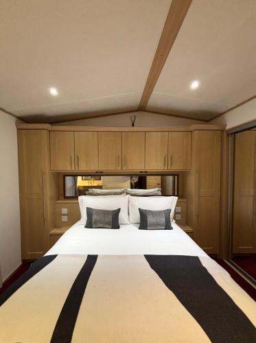 a bedroom with a large white bed with two pillows at Seven Bays Hideaway in Saint Merryn