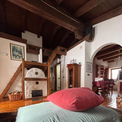 a bedroom with a bed with a red pillow at La Mansarda di Laura a Danta in Danta