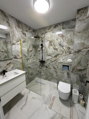 a bathroom with a toilet and a sink at Zori de Bucovina in Gura Humorului