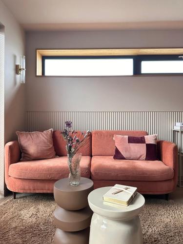 a living room with a couch and a table at Casa Souburg in Oost-Souburg