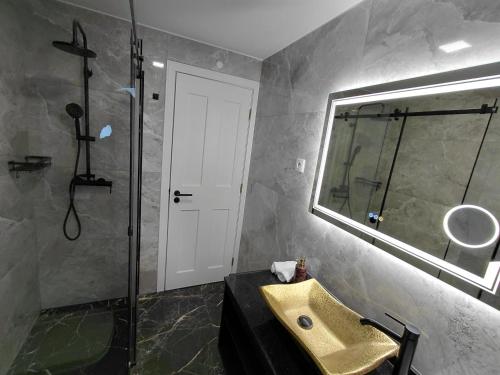 a bathroom with a sink and a shower and a mirror at Estalagem De Colares in Sintra
