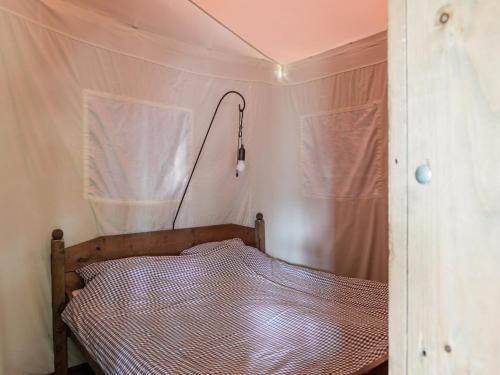 a bedroom with a bed in a tent at 6-person Duynlodge Tent in Callanstoog in Callantsoog