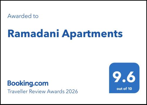a sign that reads ramadan apartments with a blue box at Ramadani Apartments in Velipojë
