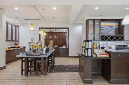 a kitchen with two bar stools in a room at Kozy Hotel Houston North in Westfield