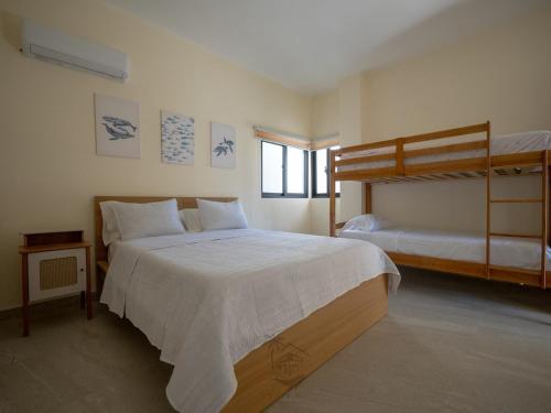a bedroom with a bed and a bunk bed at Ocean View-picuzzi Villa RI duplex Las Galeras in Piedra de La Ballena