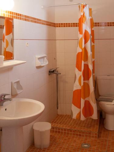 a bathroom with a sink and a toilet and a shower at ELIZA Skiathos in Skiathos Town