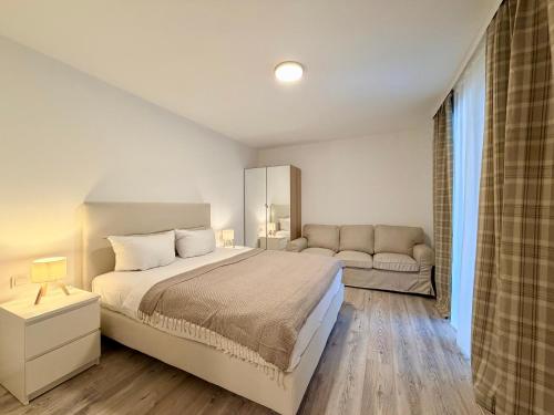 a bedroom with a large bed and a couch at GG Apartment 8 in Garmisch-Partenkirchen