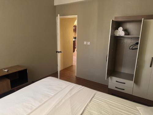 a bedroom with a bed and a door to a hallway at Northern Apartment Rentals in Paix Bouche