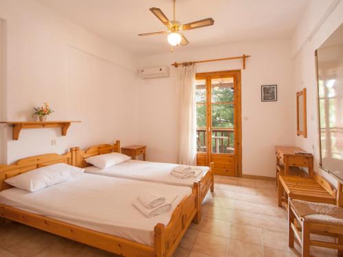 a bedroom with two beds and a window at ELIZA Skiathos in Skiathos Town