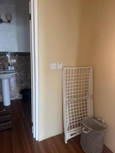 a bathroom with a sink and a white cage at Northern Apartment Rentals in Paix Bouche