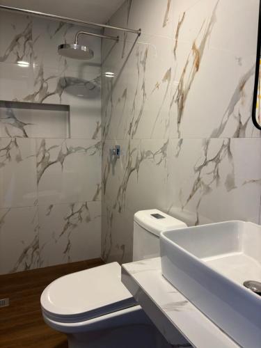 a bathroom with a toilet and a sink at Valle Alto in Cayma