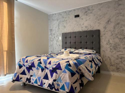 a bedroom with a bed with a blue at Valle Alto in Cayma