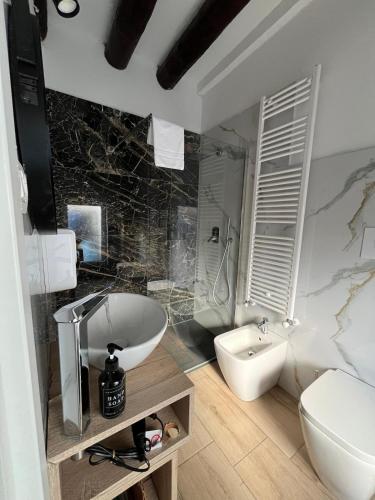a bathroom with a tub and a toilet and a sink at DAISY Air Conditioning - Free Parking - WiFi - Self Check-in in Bergamo