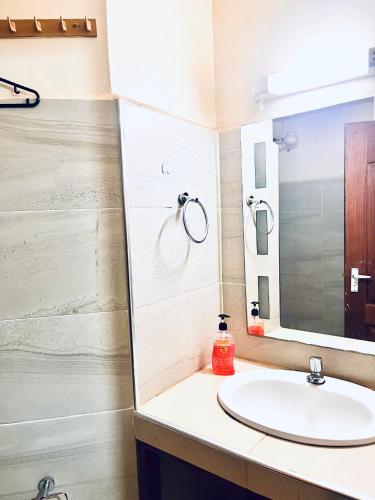 a bathroom with a sink and a mirror at B&S Studio apartment 1 , Voi Town in Voi
