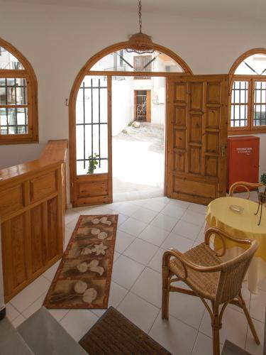 a kitchen with an archway and a table and chairs at ELIZA Skiathos in Skiathos Town