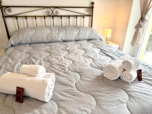 a bedroom with a bed with towels on it at Italy House in Ladispoli