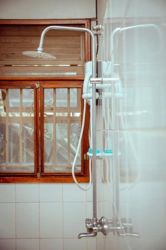 a shower in a kitchen with a sink at Serenity homes Uganda in Mbale