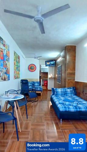 a living room with a bed and a table and chairs at Casa Del Chef Lupita in Campeche