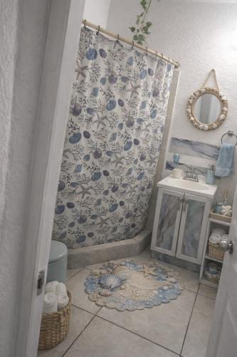 a bathroom with a shower curtain and a sink at Departamento en Marina Diamante con lago y alberca in Acapulco