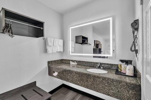a bathroom with a sink and a mirror at Baymont by Wyndham Rock Hill in Rock Hill