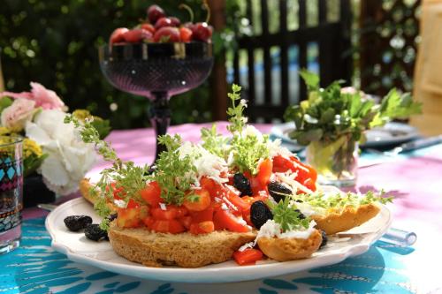 a plate of toast with vegetables on a table at Byblos Mare-The Exclusive Beach Front Villa in Skala Sotiros