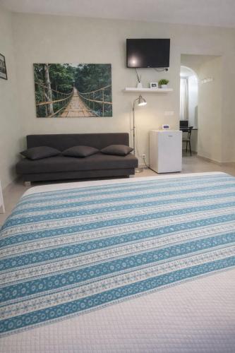 a large bedroom with a bed and a couch at Domus Flavia in Pozzuoli