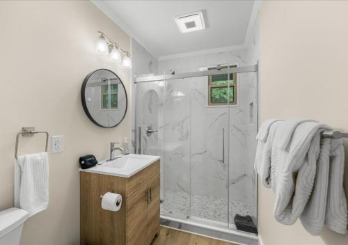 a bathroom with a shower and a sink at Hill Top Forest Cabin with Hot Tub, Fire Pit & Screened Porch in Pigeon Forge
