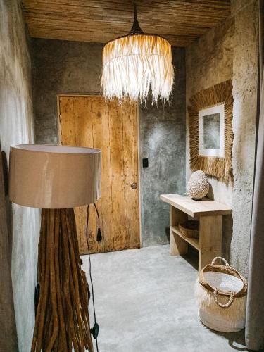 a room with a table and a chandelier at Dar Lamia Boutique Hotel - Adults Only in Manuel Antonio