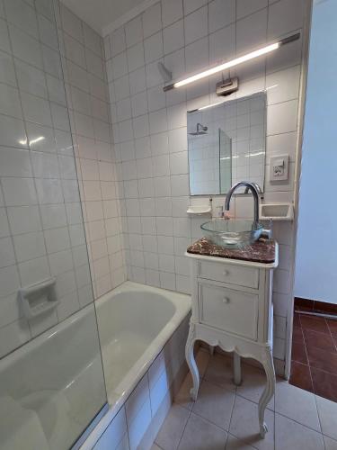 a bathroom with a tub and a sink and a mirror at Espacio 43 Terminal in La Plata